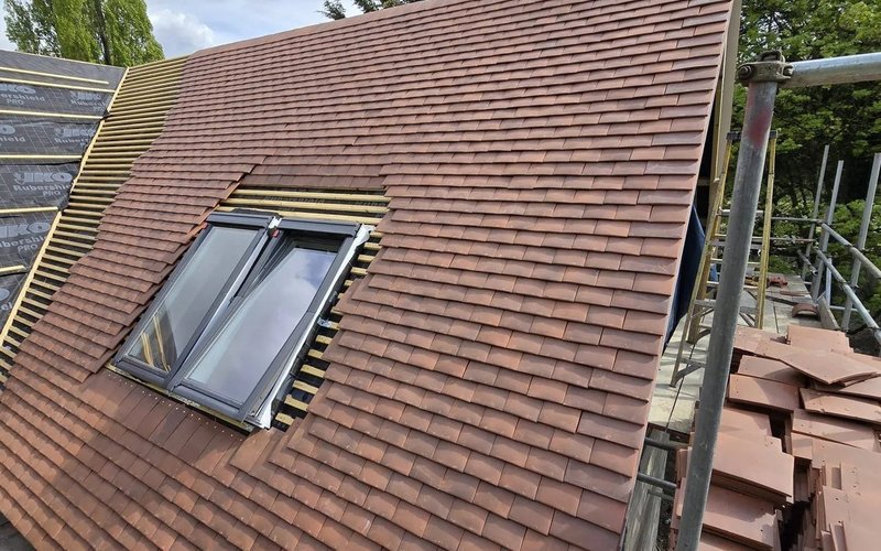 Brown tiled roof with a dormer-style roof window