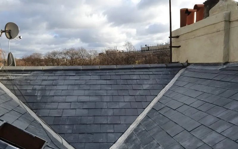 Lead valley detail joining two grey slate roof slopes