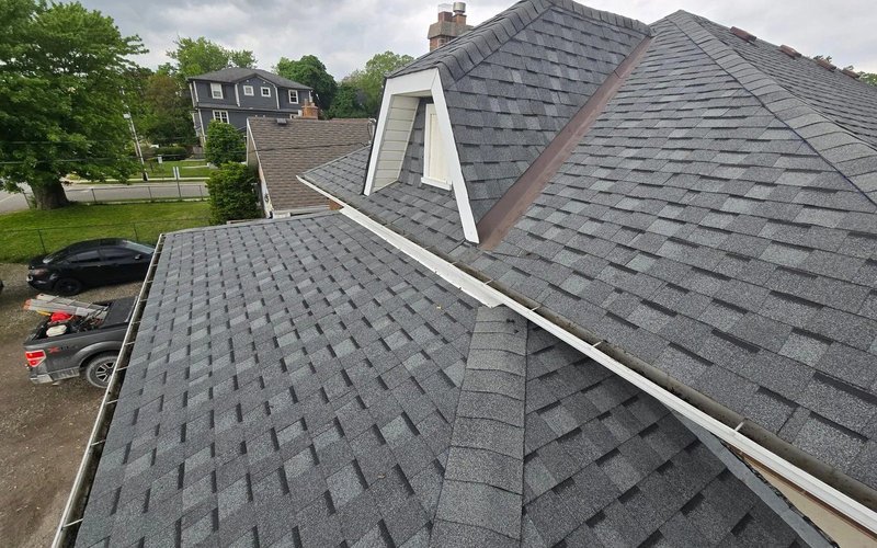Several intersecting pitched roof slopes covered with grey tiles
