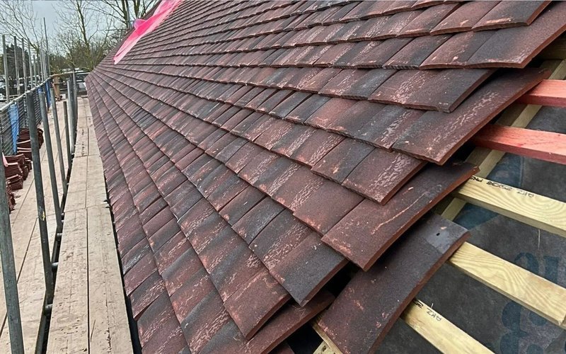 Red tiles fitted onto exposed timber roof battens